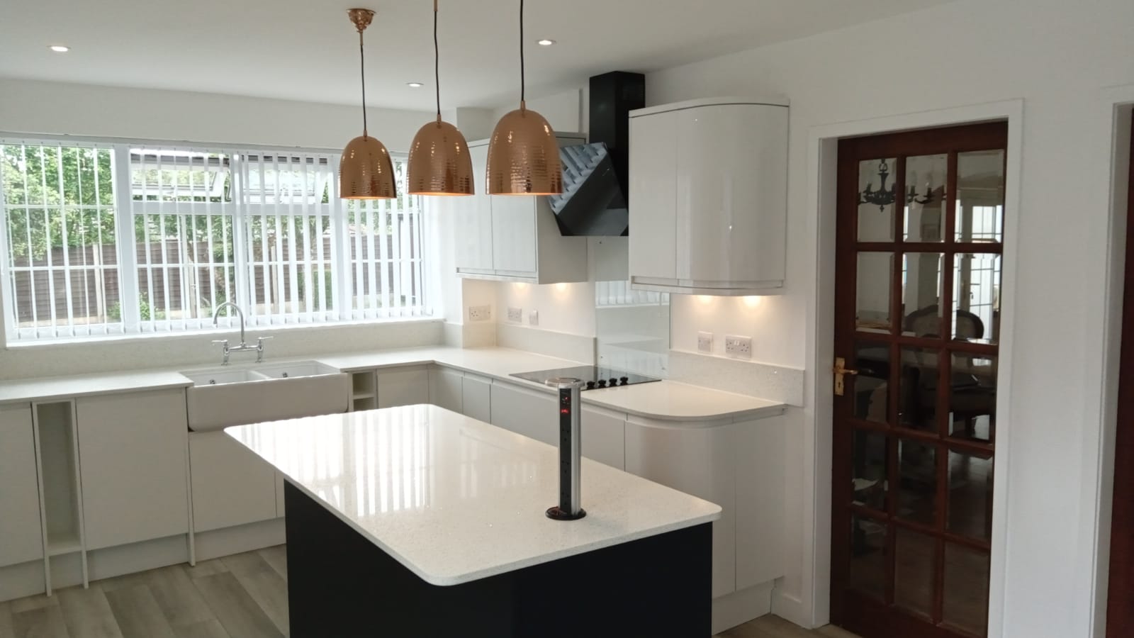 Premium white kitchen with copper pendants